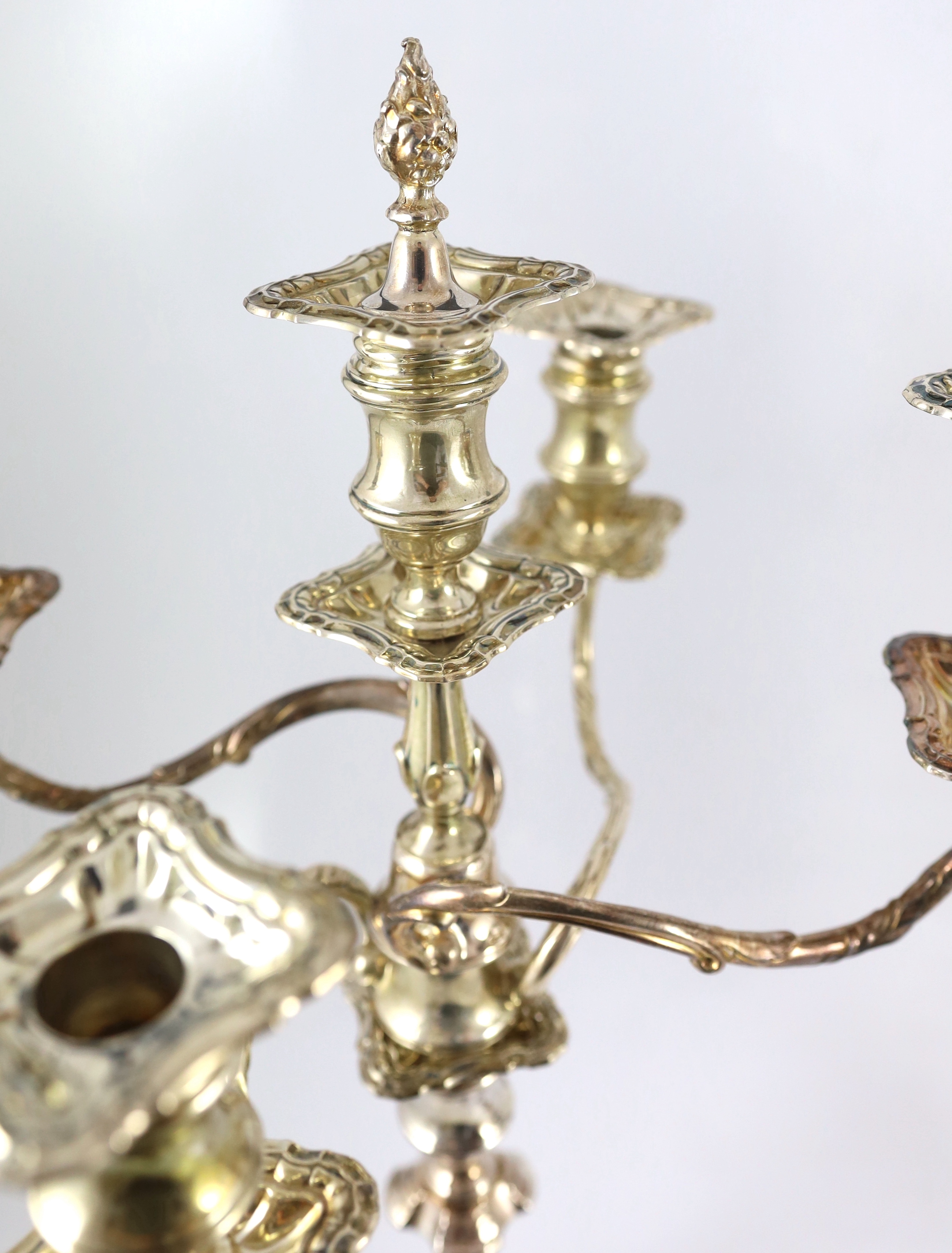 A good pair of George V silver four branch five light candelabra, by Elkington & Co.